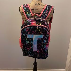 Justice book-bag. T on one side and nothing on the other. Flip book-bag.